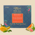 Packaging of Mogo Mogo green tea with illustrations of fruits and leaves, and text detailing the product as a tropical fruit-flavored tea by TGL Co.