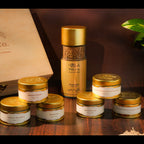 Collection of gold-topped tea containers with visible branding on a wooden surface.